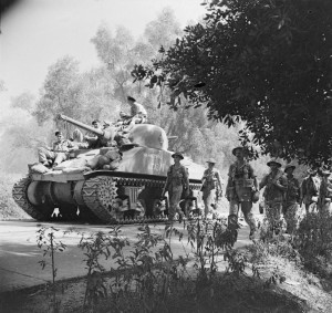 A Sherman tank and infantry advance north from Reggio