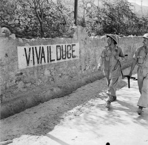 British soldiers smile at a 'Viva Il Duce' slogan on a wall in Reggio, Italy, September 1943